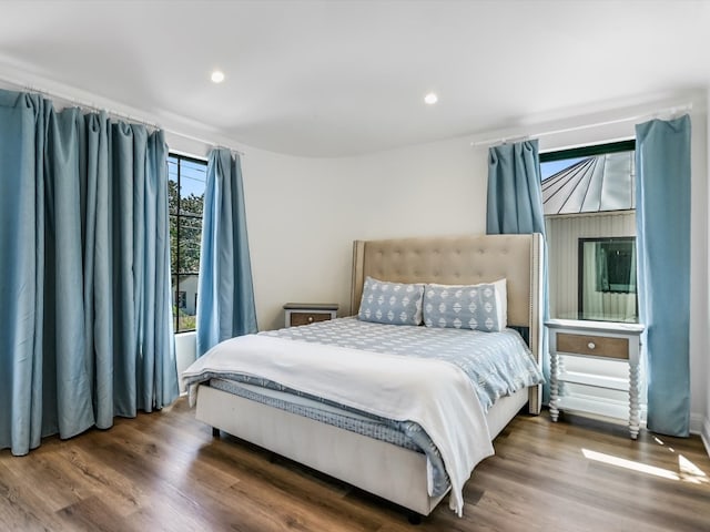 bedroom with dark wood-type flooring