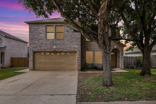 view of front of home featuring a garage and a lawn