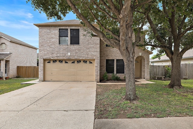 view of property with a garage and a front yard