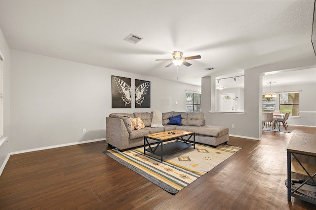 living room featuring dark hardwood / wood-style flooring and ceiling fan