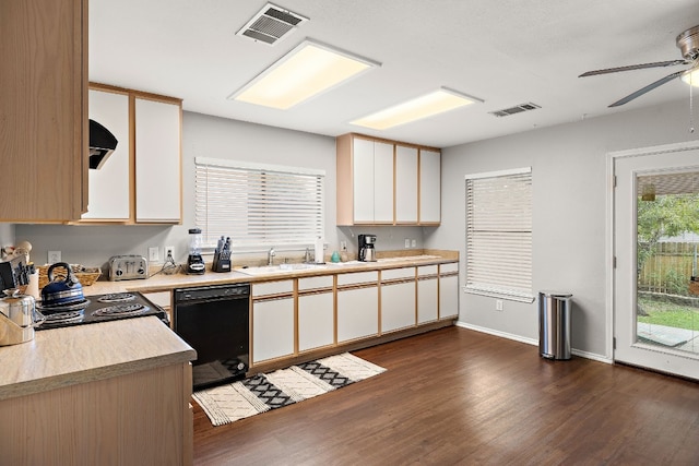 kitchen with ventilation hood, ceiling fan, dark wood-type flooring, black dishwasher, and range