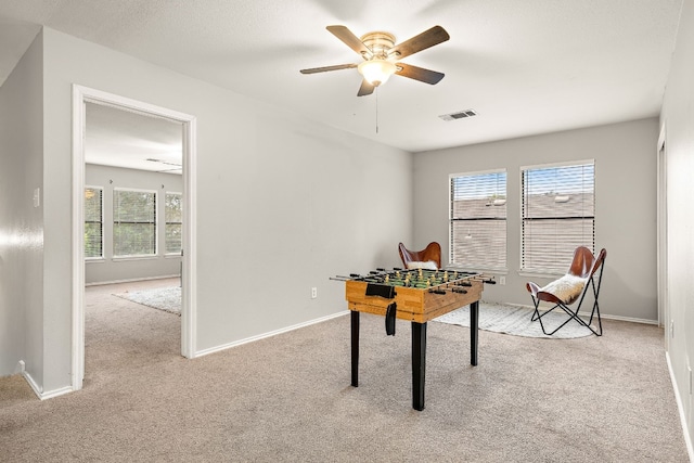 carpeted office with ceiling fan and a wealth of natural light