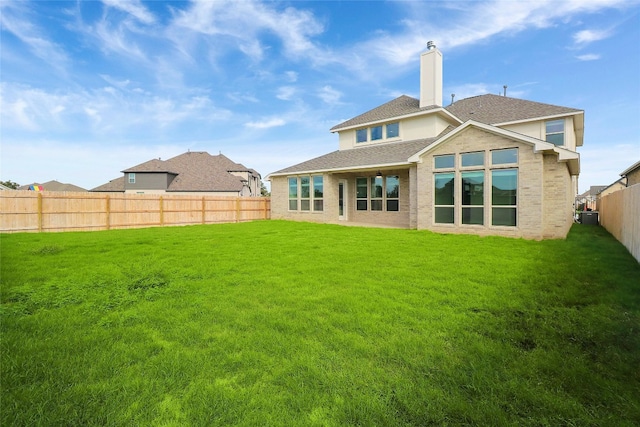 back of house featuring a lawn