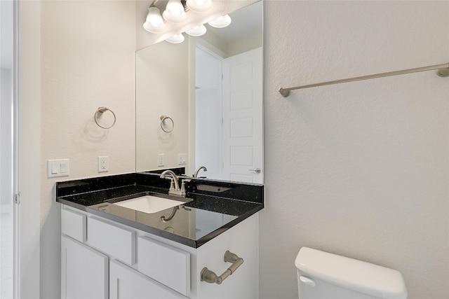 bathroom with toilet and vanity