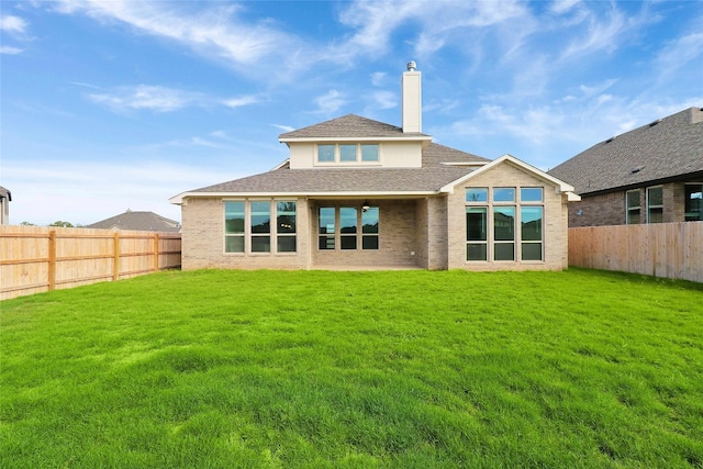 rear view of house with a lawn