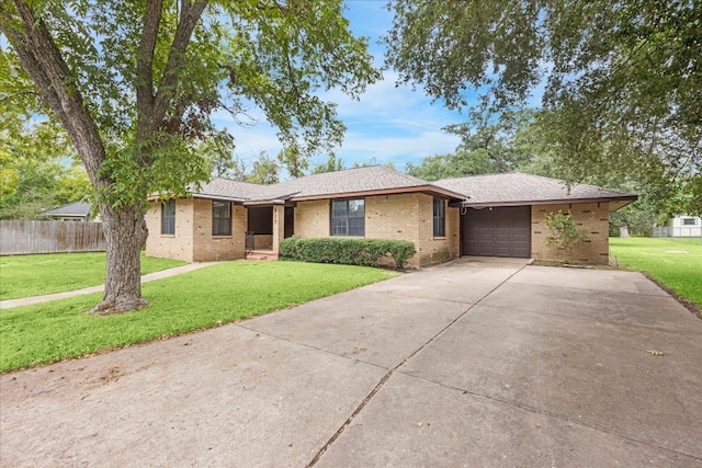 ranch-style house with a front yard and a garage