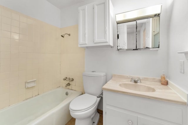 full bathroom featuring toilet, tiled shower / bath combo, and vanity