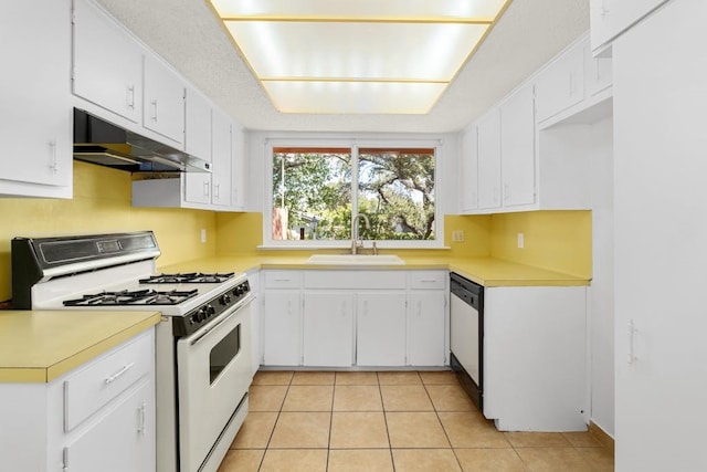 kitchen featuring light tile patterned floors, white appliances, sink, and white cabinets