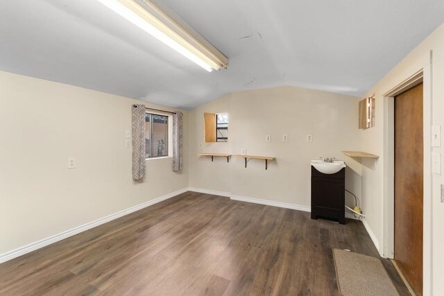 basement with dark wood-type flooring and sink