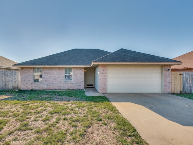 ranch-style house featuring a garage and a front yard