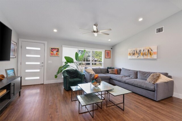 living room with ceiling fan, dark wood-type flooring, and vaulted ceiling