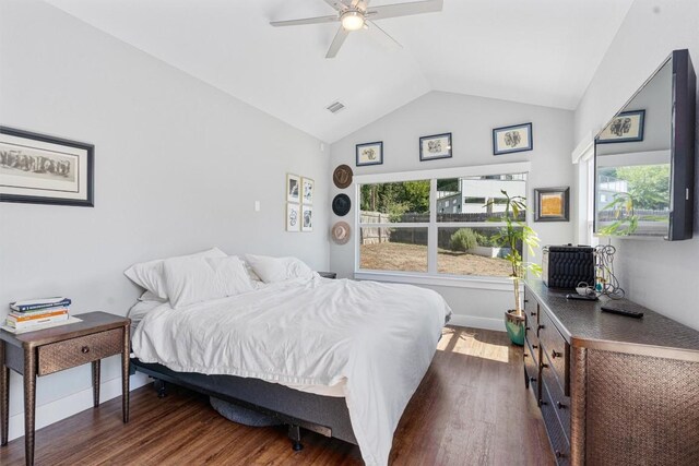 bedroom featuring dark wood-type flooring, vaulted ceiling, and ceiling fan