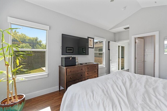 bedroom featuring dark wood-type flooring and lofted ceiling