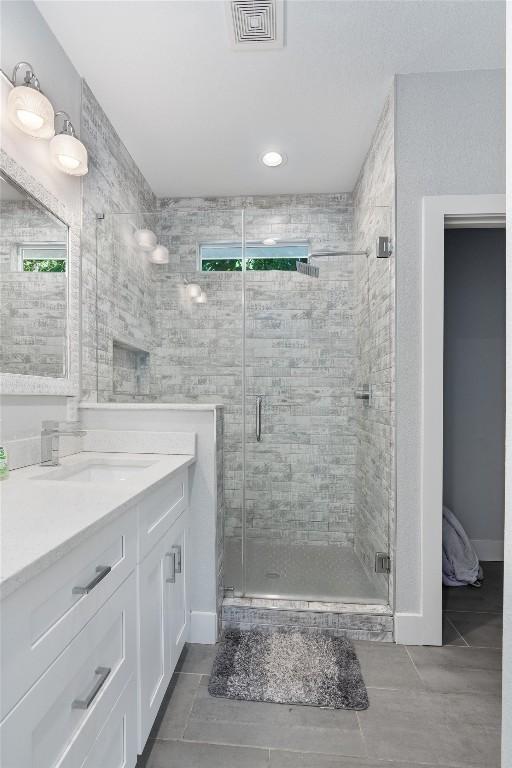 bathroom with vanity, tile patterned floors, and an enclosed shower