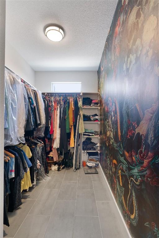 spacious closet featuring tile patterned floors