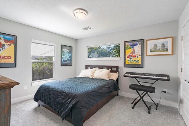 carpeted bedroom featuring a textured ceiling