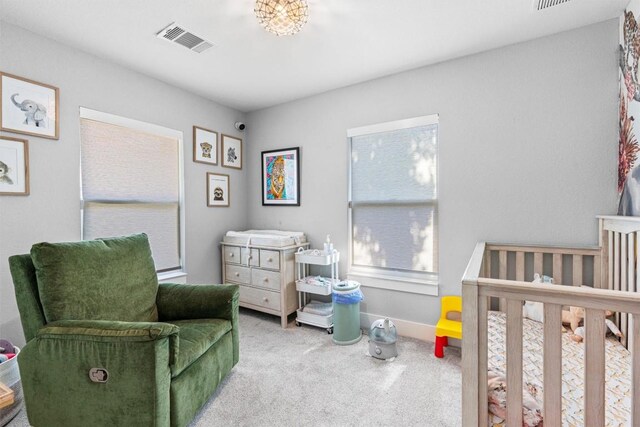 carpeted bedroom with a crib