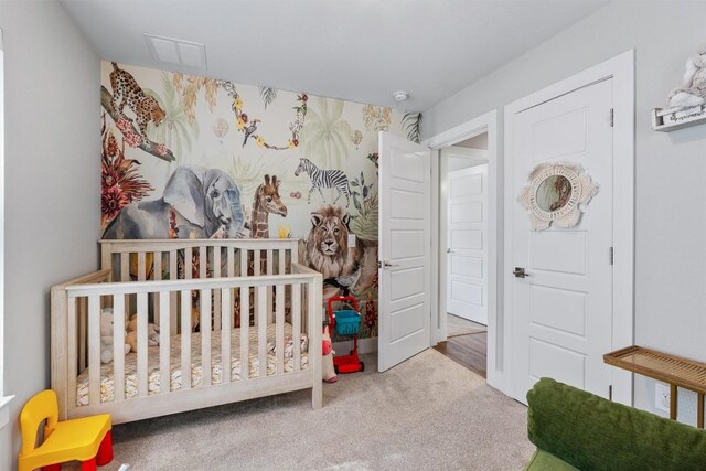 carpeted bedroom with a crib