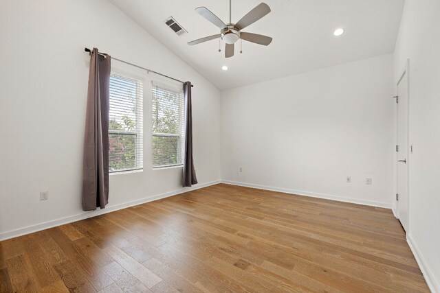 unfurnished room with ceiling fan, lofted ceiling, and light wood-type flooring