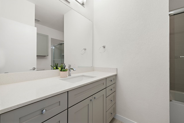 bathroom featuring vanity and combined bath / shower with glass door