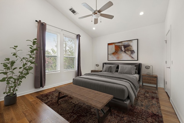 bedroom with hardwood / wood-style floors, vaulted ceiling, and ceiling fan