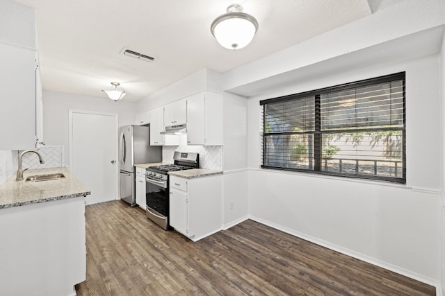 kitchen featuring backsplash, stainless steel appliances, sink, dark hardwood / wood-style floors, and white cabinets