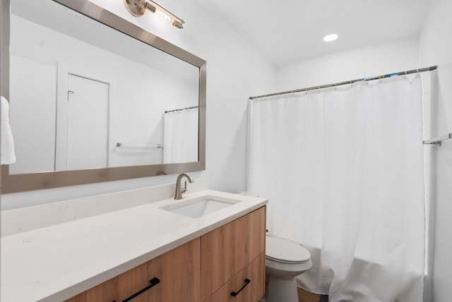 bathroom featuring vanity, toilet, and walk in shower