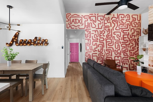 living room featuring light hardwood / wood-style flooring and ceiling fan