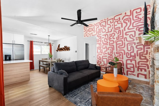 living room with ceiling fan and light hardwood / wood-style floors