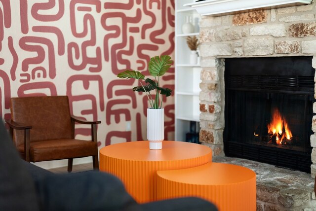 sitting room with a stone fireplace