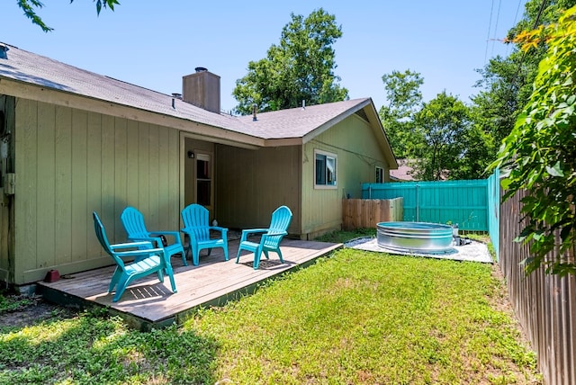 view of yard with a jacuzzi and a wooden deck