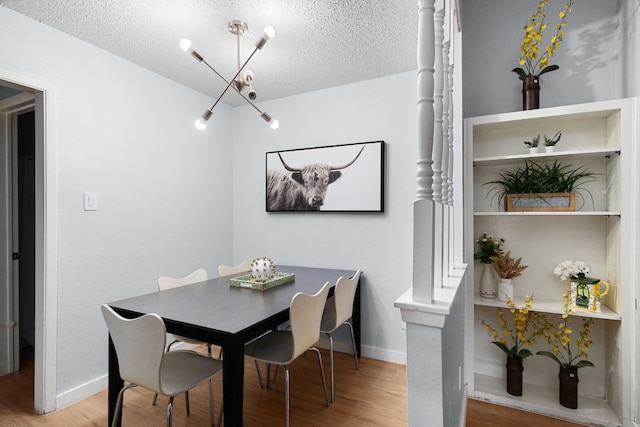 dining space featuring hardwood / wood-style flooring and a textured ceiling