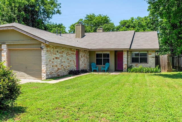 ranch-style house featuring a garage and a front lawn