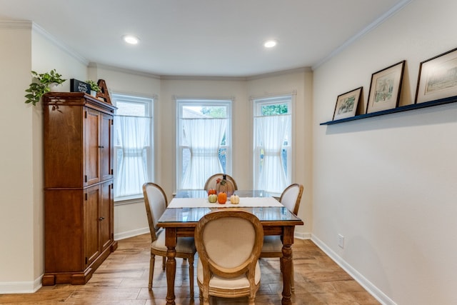 dining room featuring crown molding and light hardwood / wood-style flooring