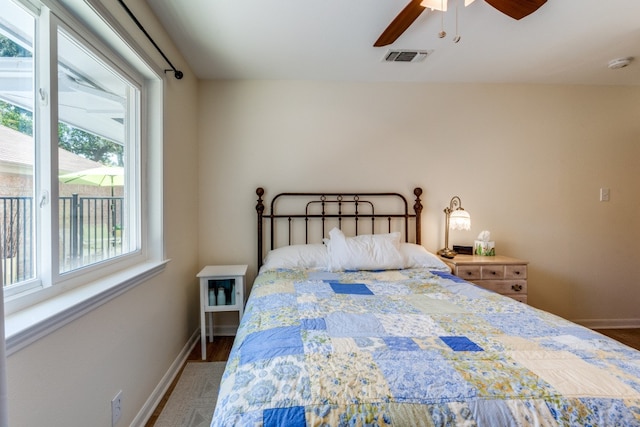 bedroom with ceiling fan and hardwood / wood-style flooring