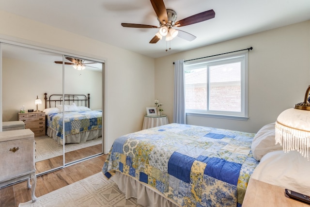 bedroom with light wood-type flooring, a closet, and ceiling fan