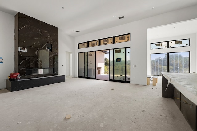 unfurnished living room featuring a high end fireplace