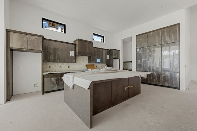 kitchen featuring a kitchen island and dark brown cabinetry