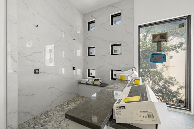 bathroom with tile walls and plenty of natural light