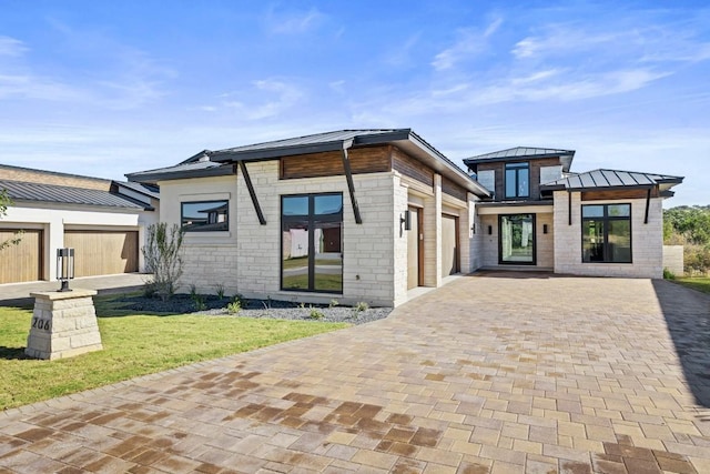 view of front of home with a garage and a front lawn