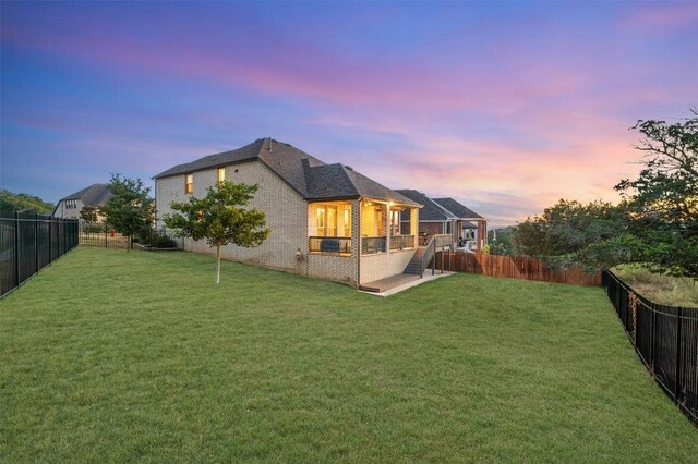 7828 Pace Ravine Dr, Lago Vista, TX 78645 - back house at dusk featuring a yard
