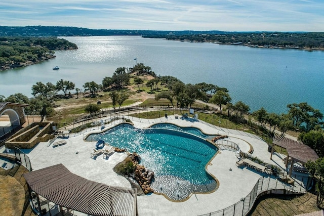 view of pool featuring a patio area and a water view