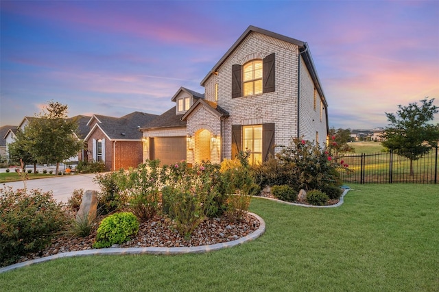 view of front of house with a lawn and a garage