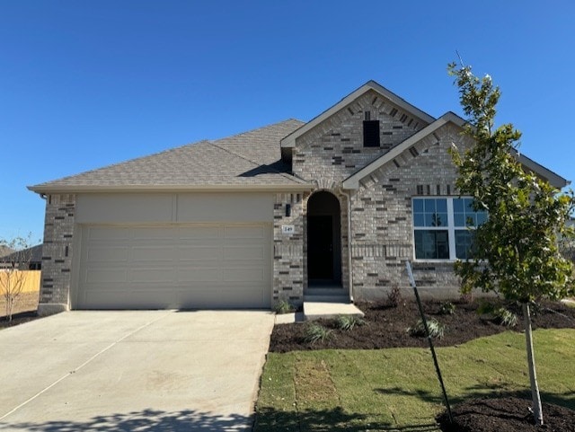 view of front of property with a garage and a front lawn