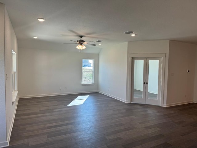 spare room with dark wood-type flooring, french doors, and ceiling fan