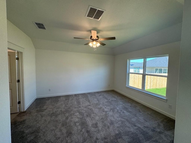 carpeted spare room featuring ceiling fan and lofted ceiling