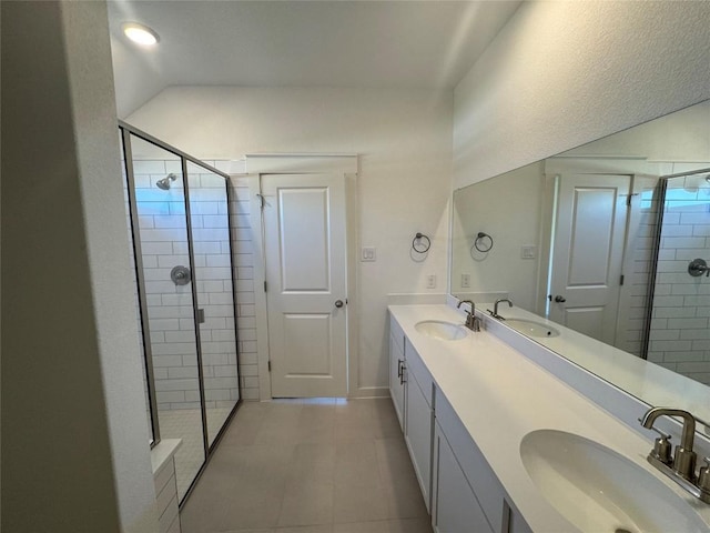 bathroom with tile patterned floors, vanity, and a shower with shower door