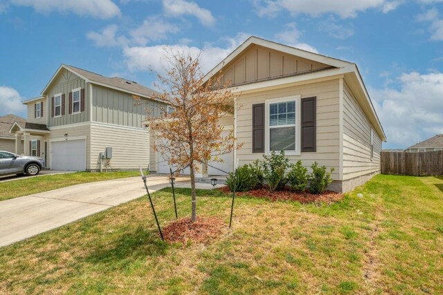 view of front of property featuring a garage and a front lawn