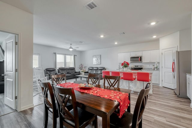 dining area featuring light hardwood / wood-style flooring and ceiling fan