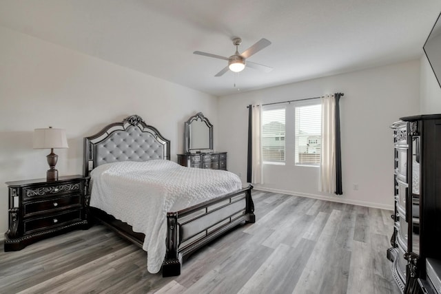 bedroom with ceiling fan and light hardwood / wood-style floors